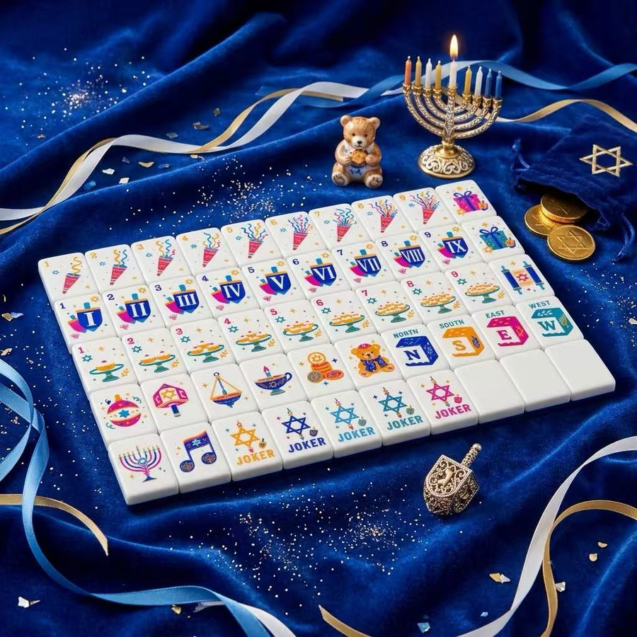 The Festival of Lights mahjong tiles arranged on blue fabric beside a menorah and dreidel