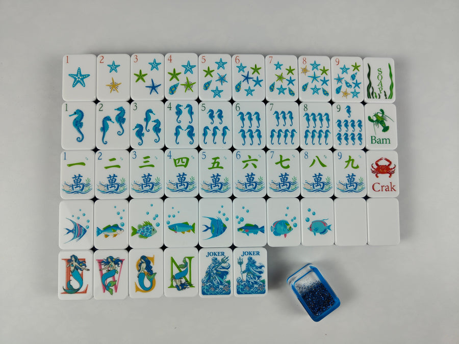 Neptune mahjong tile faces with starfish, seahorses and blue sea-life illustrations