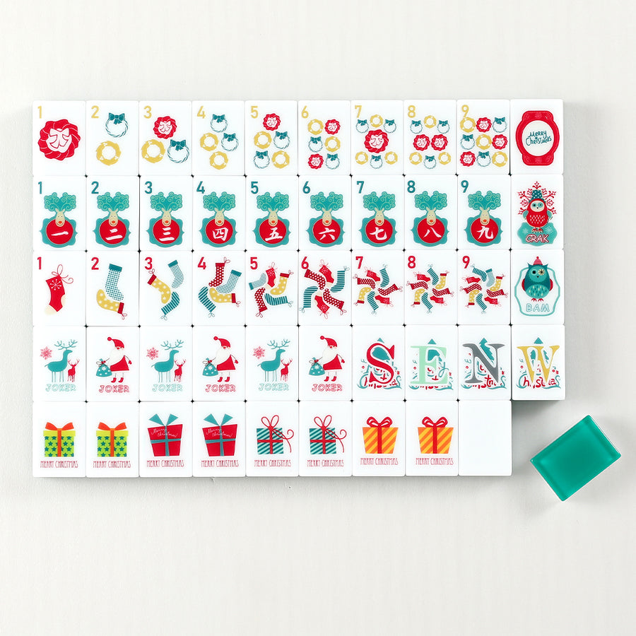 Hearthside mahjong tile faces with Christmas wreaths, stockings and gifts arranged in rows