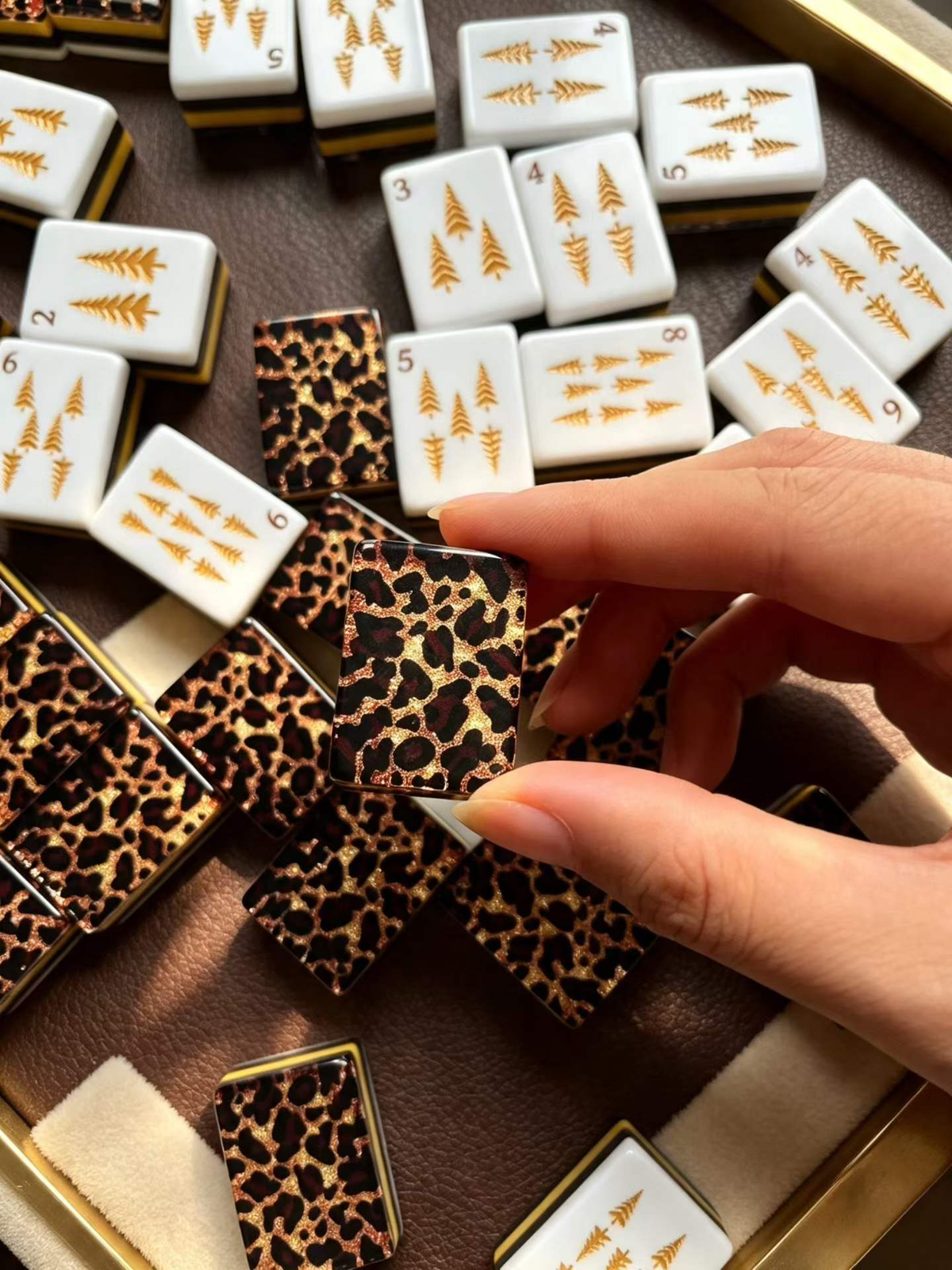 Close-up of Cheetah's Garden American Mahjong tiles with leopard-print backs and layered tile edges